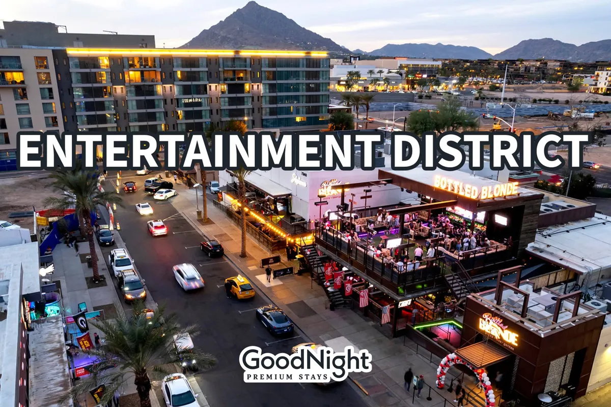 A vibrant exterior shot of Scottsdale's entertainment district, with signage, the Bottled Blonde bar, palm trees, and people out and about for dining, nightlife, and social events. The street scene is lively and inviting, emphasizing the social opportunities nearby.
